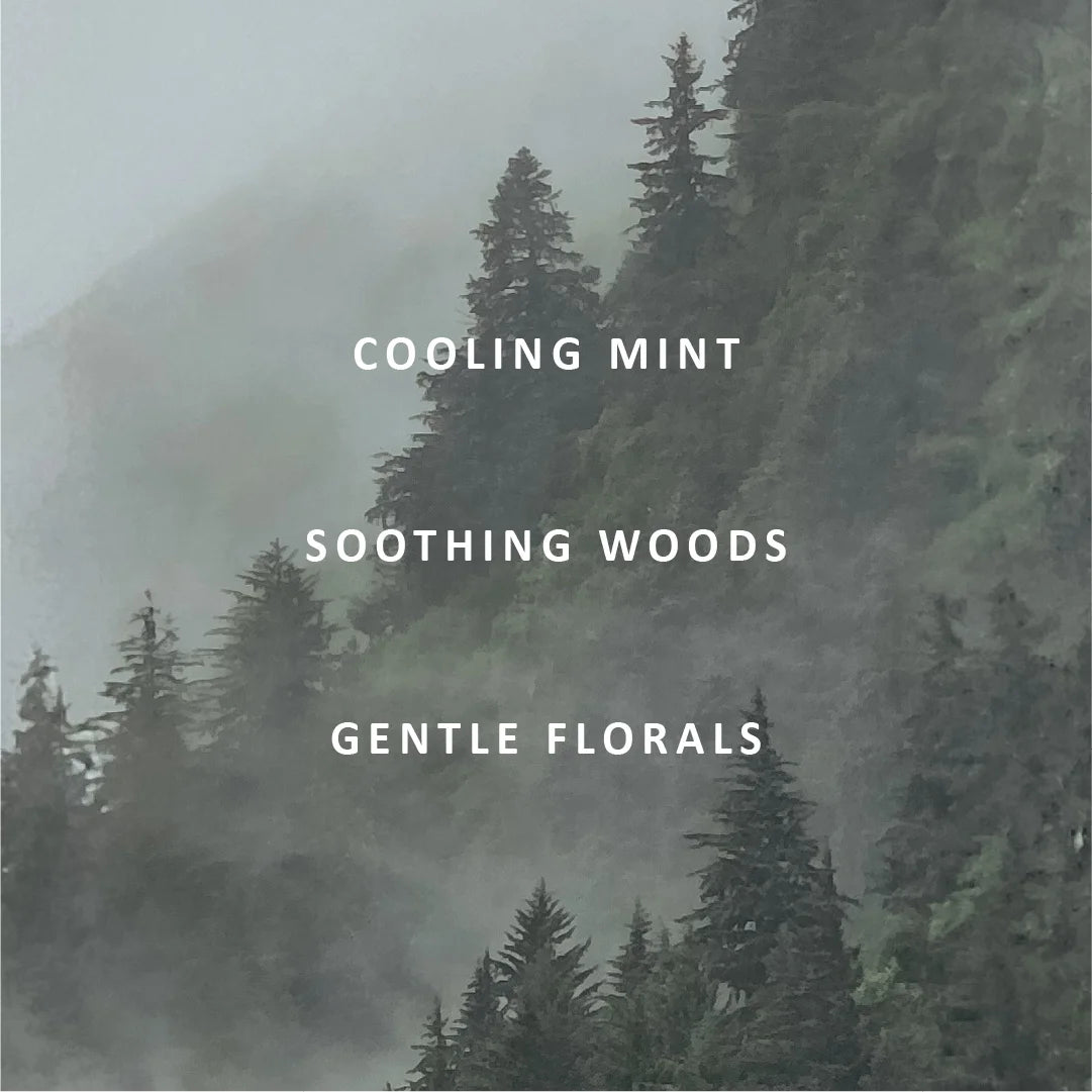 Misty evergreen forest scene with white text reading 'COOLING MINT', 'SOOTHING WOODS', and 'GENTLE FLORALS' centered on the image.